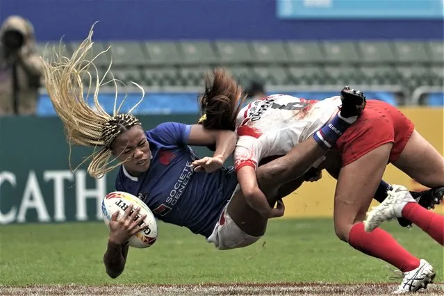 France's Ian Jason is tackled by Japan's Mei Ohtani during the first day of the Hong Kong Sevens rugby tournament in Hong Kong, Friday, March 31, 2023. (Photo by Anthony Kwan/AP Photo)
