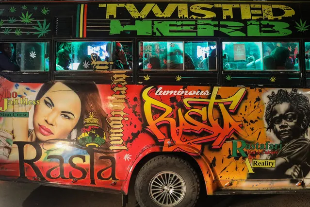 Passengers inside a matatu named “Twisted Herb” painted with graffiti portraits musicians, fitted with lights and sound system, wait for passengers at night in the streets of Nairobi, Kenya, 23 March 2018. (Photo by Daniel Irungu/EPA/EFE)