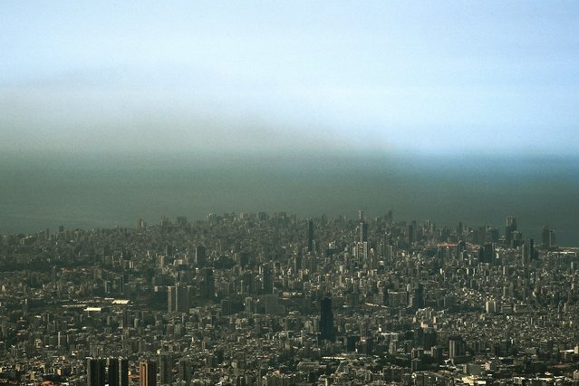 This picture shows a cloud of smog over Lebanon's capital Beirut on August 14, 2025. A World Bank climate and development report last year said the transport sector was Lebanon's second-biggest contributor to greenhouse gas and air pollution, accounting for a quarter of emissions, only behind the energy sector. (Photo by Joseph Eid/AFP Photo)