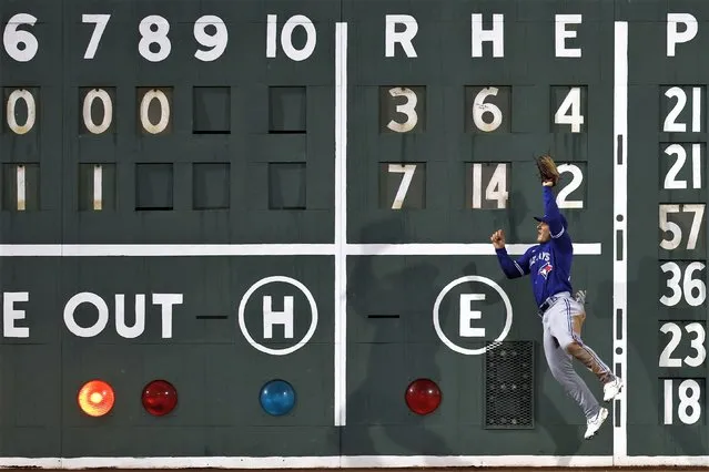 Toronto Blue Jays' Daulton Varsho makes the catch on the fly out by Boston Red Sox's Enmanuel Valdez during the eighth inning of a baseball game, Wednesday, May 3, 2023, in Boston. (Photo by Michael Dwyer/AP Photo)