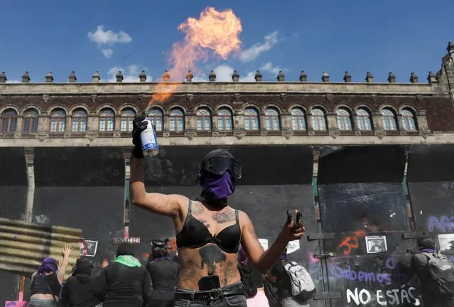 Demonstrators take part in a protest to mark International Women's Day in Mexico City, Mexico on March 8, 2022. (Photo by Raquel Cunha/Reuters)