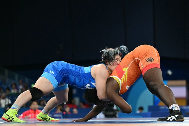 Colombia's Tatiana Renteria Renteria (red) wrestles Japan's Yuka Kagami (blue) in their women's freestyle 76kg wrestling semi-final match at the Champ-de-Mars Arena during the Paris 2024 Olympic Games, in Paris on August 10, 2024. (Photo by Punit Paranjpe/AFP Photo)