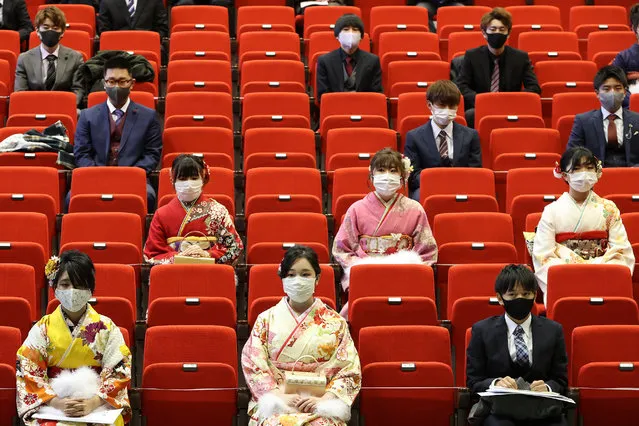 Participants sit with social distancing as a preventive measure against the Covid-19 coronavirus during a coming-of-age ceremony in Namie, Fukushima Prefecture on January 9, 2021. (Photo by JIJI Press/AFP Photo)