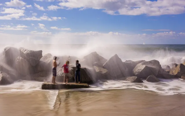 “Simple Moment”. 3 kids getting showered by the Pacific Ocean, Simple moment in life! Location: Los Angeles, California. (Photo and caption by Stephane Couture/National Geographic Traveler Photo Contest)