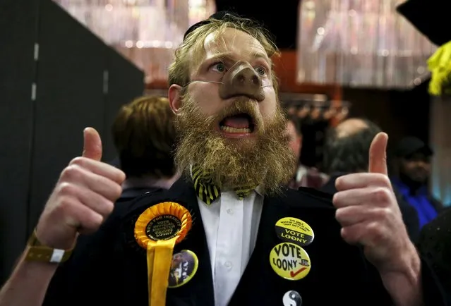 The Official Monster Raving Loony Pary candidate Sir Oink A Lot gestures after arriving at the count for the Oldham West and Royton by-election at the Civic Centre in Oldham, northern England, December 4, 2015. Residents of this former industrial town outside Manchester will be the first voters in Britain to give their verdict on Labour's new leader, Jeremy Corbyn, who has split the party by pushing a hard-left agenda. (Photo by Phil Noble/Reuters)