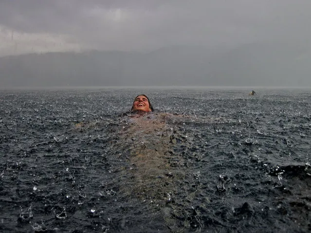 “Merit Winner: Swimming in the Rain”. My sister in the south of Chile. We are sitting at home next to the fireplace in our southern lake house when it suddenly began to pour uncontrollably. Had to rush into the lake to take this snapshot! Location: Lago Caburgua, Chile. (Photo and caption by Camila Massu/National Geographic Traveler Photo Contest)