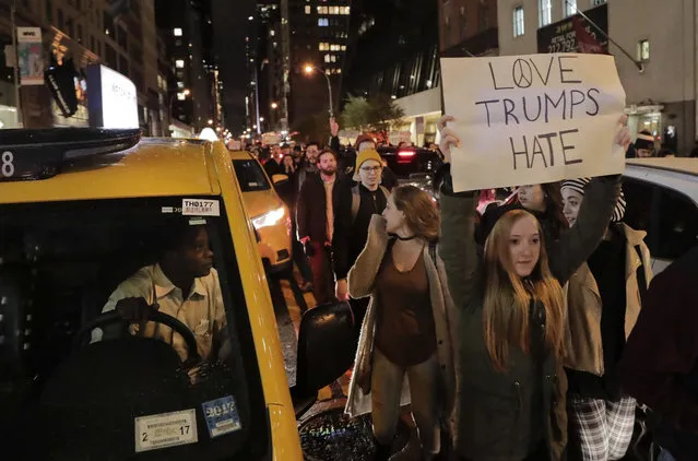 Protesters march along 57th Street toward Trump Tower, Wednesday, November 9, 2016, in New York, in opposition of Donald Trump's presidential election victory. (Photo by Julie Jacobson/AP Photo)