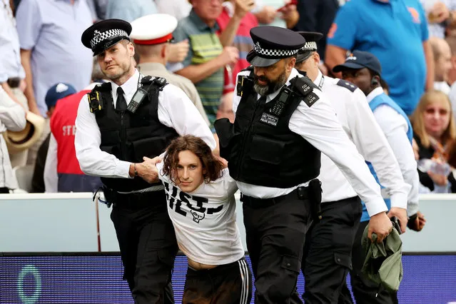 A “Just Stop Oil” protester is taken away by Police officers during Day One of the LV= Insurance Ashes 2nd Test match between England and Australia at Lord's Cricket Ground on June 28, 2023 in London, England. (Photo by Ryan Pierse/Getty Images)