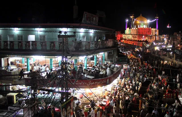 A general view of the illuminated shrine of Muslim Sufi Saint Hazrat Lal Shahbaz Qalandar in Sehwan Sharif, Pakistan, in the early hours of 28 June 2013. Hazrat Lal Shahbaz Qalandar (1177-1274) was a Persian (Tajik) Sufi saint, philosopher, poet, and qalandar. Born Syed Usman Shah Marwandi, he belonged to the Suhrawardiyya order of Sufis. He preached religious tolerance among Muslims and Hindus. Thousands of pilgrims visit his shrine every year, especially on the occasion of his Urs. (Photo by Nadeem Khawer/EPA/EFE)