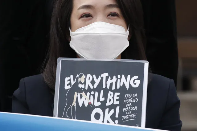 A South Korean lawmaker Choi Hye Young holds a sign during a news conference supporting Myanmar's democracy in front of the Myanmar Embassy in Seoul, South Korea, Wednesday, March 10, 2021. (Photo by Lee Jin-man/AP Photo)