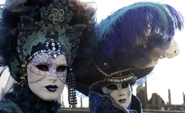Masked revellers pose at Saint Mark's square during Carnival in Venice, February 8, 2015. The carnival runs until February 17. (Photo by Stefano Rellandini/Reuters)