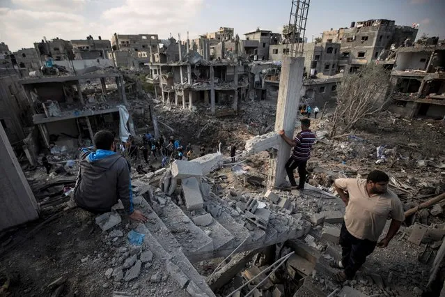 Palestinians inspect their destroyed houses following overnight Israeli airstrikes in town of Beit Hanoun, northern Gaza Strip, Friday, May 14, 2021. (Photo by Khalil Hamra/AP Photo)