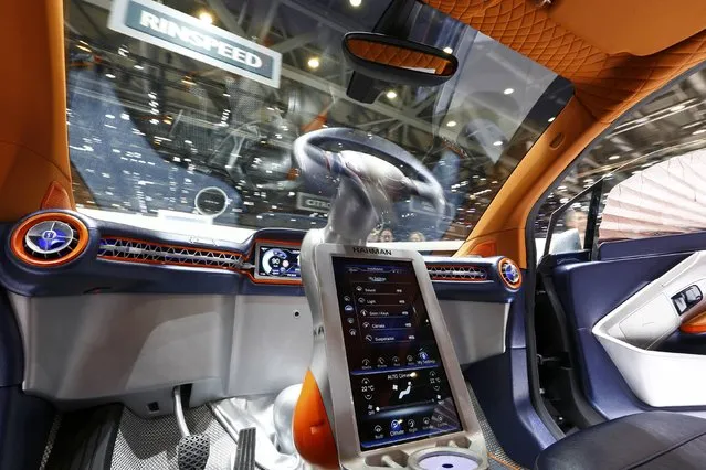 The steering wheel movement is seen inside a Rinspeed Budii self-driving electric city car during the second press day ahead of the 85th International Motor Show in Geneva March 4, 2015. Mounted on a swivelling motorised arm the steering wheel can be used to drive from either side of the car. When not in use the steering wheel rests in the middle of the dashboard.  REUTERS