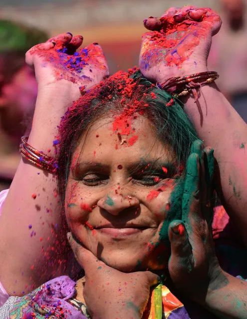 Members of the Nepalese ethnic Madhesi community daub each other's faces with coloured powders during Holi festival celebrations in Kathmandu on March 6, 2015. The Holi festival of colours is a riotous celebration of the coming of spring and falls on the day of the full moon in March every year. AFP PHOTO / PRAKASH MATHEMA        (PRAKASH MATHEMA/AFP/Getty Images)