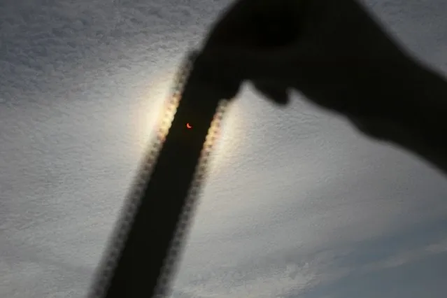 A person holds up a strip of exposed photographic film to observe a partial solar elcipse in Szczecin March 20, 2015. (Photo by Agencja Gazeta/Reuters)