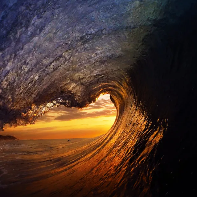 An intense sunrise framed by a wave on September, 25, 2015, in Durban, South Africa. (Photo by Marck Botha/Barcroft Media)
