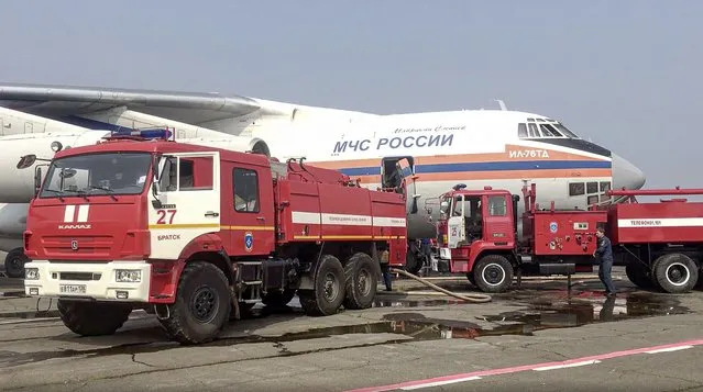This image taken from video provided by the Russian Emergency Ministry Sunday, June 13, 2021 shows a IL-76 aircraft loading with water at an airfield in Irkutsk region. To eliminate the emergency situation associated with forest fires in the Katangsky region, an Il-76 aircraft of the Ministry of Emergencies of Russia arrived in the Irkutsk region. As of the morning of June 13, 2021, about 13 wildfires are active in the region on a total area of 34149.4 hectares. (Photo by Russian Emergency Ministry Press Service via AP Photo)