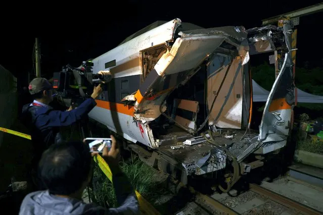A damaged train carriage is seen at the site of the deadly train derailment at a tunnel, north of Hualien, Taiwan on April 4, 2021. A Taiwan express train with almost 500 aboard derailed in a tunnel after hitting a truck that had slid down a bank onto the track, killing at least 50 passengers in the island's worst rail disaster in seven decades. (Photo by Ann Wang/Reuters)