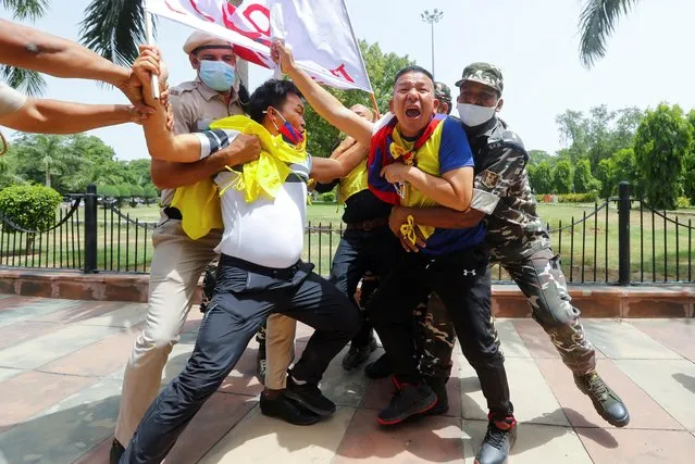 Police officers detain Tibetan demonstrators during a protest against Chinese Communist Party's 100-year anniversary celebrations, outside Chinese Embassy in New Delhi, India July 1, 2021. (Photo by Adnan Abidi/Reuters)