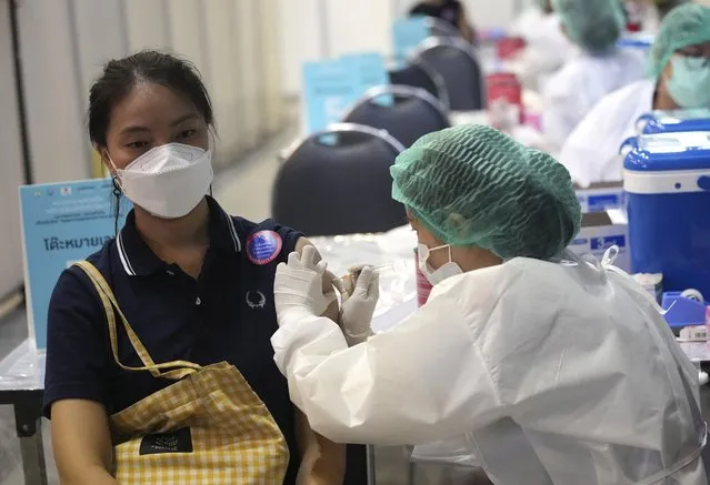 A health worker administers a dose of the Sinovac COVID-19 vaccine to a woman in Bangkok, Thailand, Monday, May 31, 2021. (Photo by Sakchai Lalit/AP Photo)