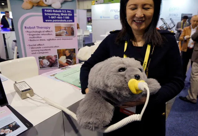 Christine Hsu shows off the Paro seal pup therapeutic robot at the Robotics Marketplace at CES in Las Vegas, U.S., January 5, 2017. (Photo by Rick Wilking/Reuters)