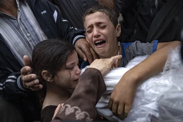 Palestinians mourn their relatives killed in the Israeli bombardment of the Gaza Strip, in the hospital in Khan Younis, Tuesday, November 14, 2023. (Photo by Fatima Shbair/AP Photo)