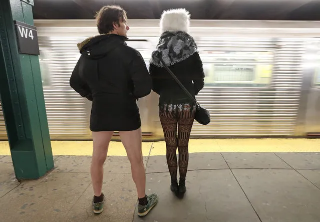 Leon Feingold, left, and Patrizia Calvio wait for a train, minus their pants, at the West 4th Street Station during the 18th annual No Pants Subway Ride, January 13, 2019, in New York. (Photo by Kathy Willens/AP Photo)