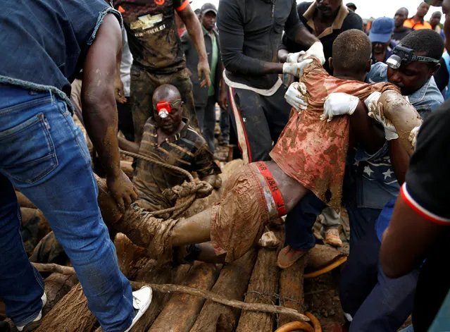 A rescued artisanal miner is carried from a pit as retrieval efforts proceed for trapped illegal gold miners in Kadoma, Zimbabwe, February 16, 2019. (Photo by Philimon Bulawayo/Reuters)