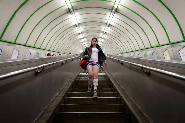 A participant in the13th annual International “No Pants Subway Ride” enters a London underground station in London, on January 12, 2014. (Photo by Leon Neal/AFP Photo)