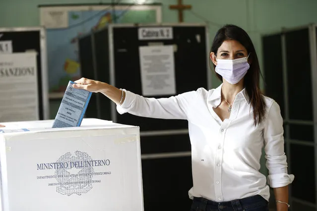 Rome Mayor Virgina Raggi poses for photographers as she casts her ballot at a polling station, in Rome, Sunday, October 3, 2021. Millions of people in Italy started voting Sunday for new mayors, including in Rome and Milan, in an election widely seen as a test of political alliances before nationwide balloting just over a year away. (Photo by Cecilia Fabiano/LaPresse via AP Photo)