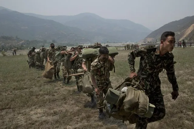 Nepalese soldiers prepare to board one of U.S. Ospreys which are used to deploy them in the quake affected mountainous areas in Manthali, Nepal, Thursday, May 7, 2015. (Photo by Bernat Amangue/AP Photo)