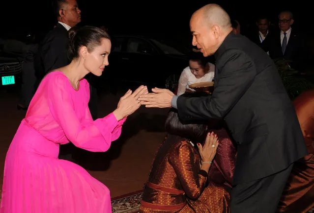 Actress Angelina Jolie (L) greets King Norodom Sihamoni of Cambodia as she arrives for the opening ceremony of the film “First They Killed My Father” in Siem Reap province, Cambodia February 18, 2017. (Photo by Reuters/Stringer)