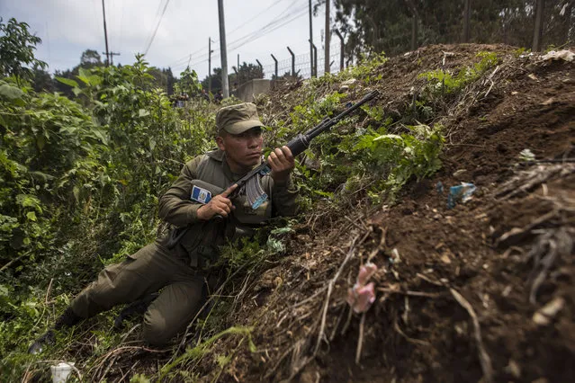 A soldier takes position outside the Pavon Rehabilitation Model Farm after a shooting inside the prison in Fraijanes, Guatemala, Tuesday, May 7, 2019. At least three people were killed and 10 people were wounded in the shooting, authorities said. (Photo by Oliver De Ros/AP Photo)