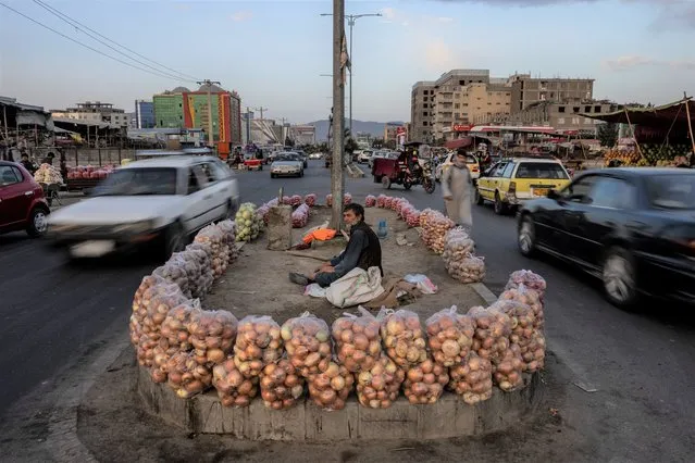 An Afghan man sells fruit in the middle of a street in Kabul, Afghanistan, Wednesday, September 22, 2021. (Photo by Bernat Armangue/AP Photo)