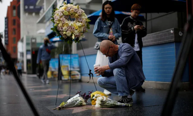 A person kneels by the star of late actor Doris Day on the Hollywood Walk of Fame in Los Angeles, California, U.S., May 13, 2019. (Photo by Mario Anzuoni/Reuters)