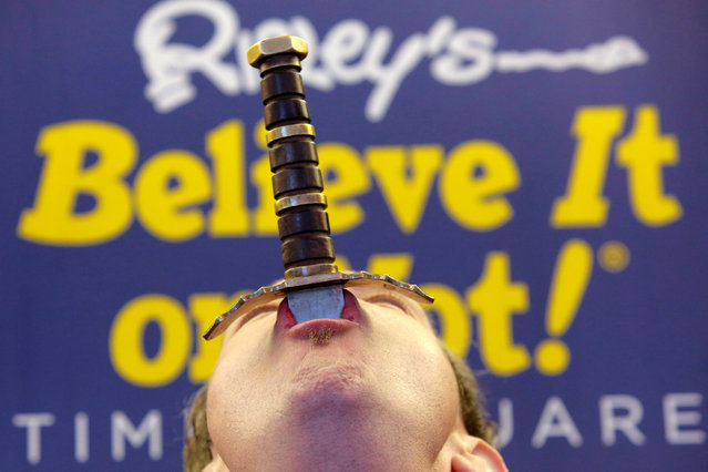 Sword swallower Fred “The Great Fredini” Kahl swallows a sword at Ripley's Believe It or Not! Times Square Odditorium to celebrate World Sword Swallower's Day in Manhattan, New York, U.S., February 25, 2017. (Photo by Andrew Kelly/Reuters)
