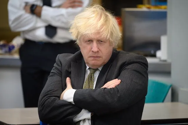 Britain's Prime Minster Boris Johnson speaks with members of the Metropolitan Police in their break room, as he makes a constituency visit to Uxbridge police station on December 17, 2021 in Uxbridge, England. (Photo by Leon Neal/Getty Images)