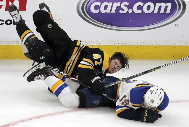 Boston Bruins' Torey Krug (47) and St. Louis Blues' Robert Thomas (18) crash to the ice during the third period in Game 1 of the NHL hockey Stanley Cup Final, Monday, May 27, 2019, in Boston. (Photo by Charles Krupa/AP Photo)