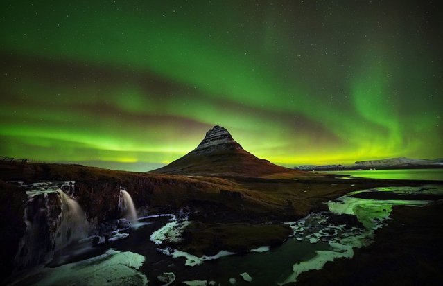 The Northern Lights over Kirkjufell mountain which sits on North coast of iceland's Snaefellsnes peninsula near the town of Grundarfjordur on Wednesday, December 6, 2023. (Photo by Owen Humphreys/PA Images via Getty Images)