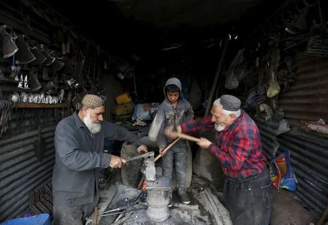 Afghan blacksmiths work at their shop in Kabul, Afghanistan March 24, 2016. (Photo by Mohammad Ismail/Reuters)