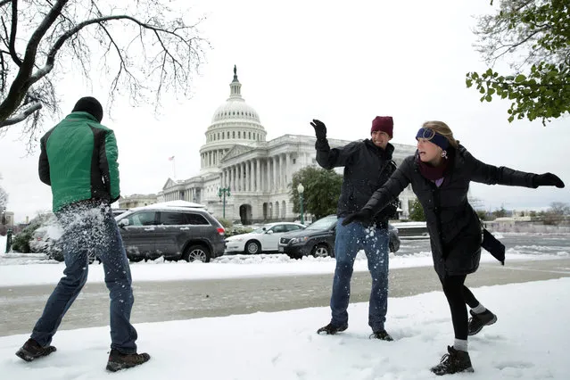 Tourists Jake Lambert, Clay Lambert and Kelsey Chaloux from Orlando, Florida play with snowballs on Capitol Hill in Washington, U.S., March 14, 2017. (Photo by Yuri Gripas/Reuters)