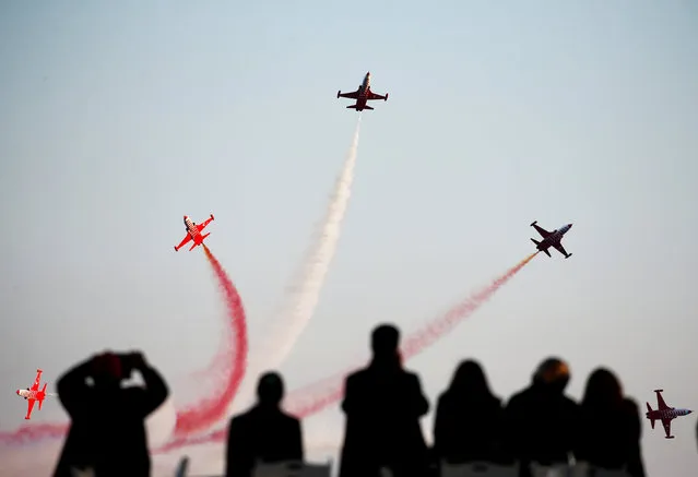 The Turkish Stars aerobatic team fly their Northrop F-5 Freedom Fighters over a Turkish memorial during a ceremony marking the 102nd anniversary of Battle of Canakkale, also known as the Gallipoli Campaign, in Canakkale, Turkey, March 18, 2017. (Photo by Osman Orsal/Reuters)