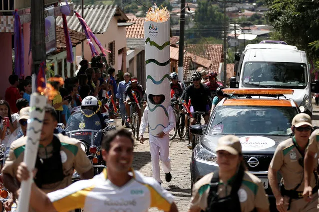 A man dressed as a olympic torch takes part in the Olympic Flame torch relay in Corumba de Goias, Goias state, Brazil, May 4, 2016. (Photo by Fernando Soutello/Reuters/Rio2016)