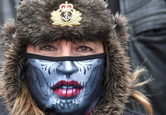 A woman wearing a protective face mask joins former British armed forces members and supporters at a “Respect Our Veterans” parade and rally, following the collapse of the trial in Belfast of two British soldiers over the killing of Official IRA leader Joe McCann, London, Britain, May 8, 2021. (Photo by Toby Melville/Reuters)