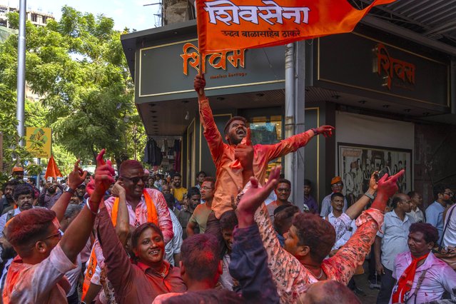 Supporters of Shiv Sena (Uddhav Balasaheb Thackeray) dance as they celebrate their party's lead during the counting of votes in India's national election in Mumbai, India, Tuesday, June 4, 2024. (Photo by Rafiq Maqbool/AP Photo)