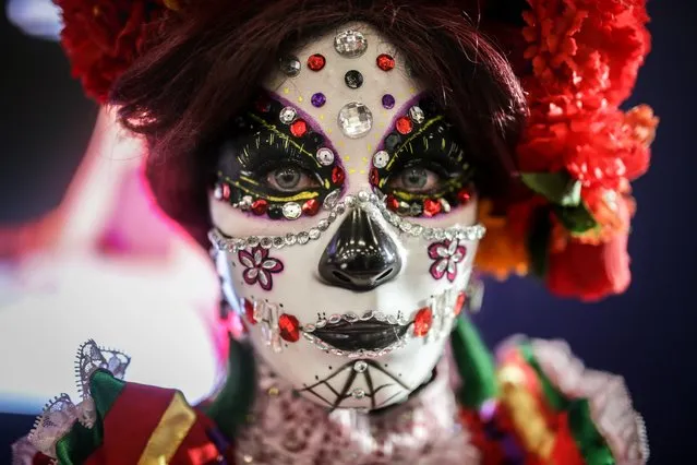 Young Mexican women, dressed as La Catrina, a Mexican pop culture icon representing the Death, take part at the ANATO tourism fair, one of the largest in Latin America is being held in Corferias conference center organized by the Colombian Association of Travel, the first one face-to-face during the COVID-19 pandemic in Bogota, Colombia on June 16, 2021. The largest tourism showcase and business fair in Colombia are buoyant during the economic reactivation in the country after the harsh containment measures due to the COVID-19 pandemic. Organized by ANATO, the Colombian Association of Travel and Tourism Agencies, the event features representatives from all 32 Colombian departments and Argentina as the special guest, all vying for the best opportunities for trade with both local tourism operators and guides, and larger international tour operators (Photo by Juancho Torres/Anadolu Agency via Getty Images)