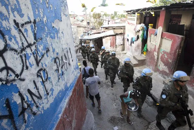 In this February 22, 2017 photo, U.N. peacekeepers from Brazil patrol the Cite Soleil slum in Port-au-Prince, Haiti. They faced no greater threat than a few barking dogs along some of the same streets where pitched gun battles between gangs and U.N. peacekeepers used to be a daily occurrence. (Photo by Dieu Nalio Chery/AP Photo)