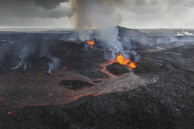 Panoramic view of the Svartsengi area with the active craters and lava flows in the foreground, near Grindavik, Iceland, Monday, June 3, 2024. The white steam in the top right is produced by the Powerplant and the Blue Lagoon area. (Photo by Marco di Marco/AP Photo)