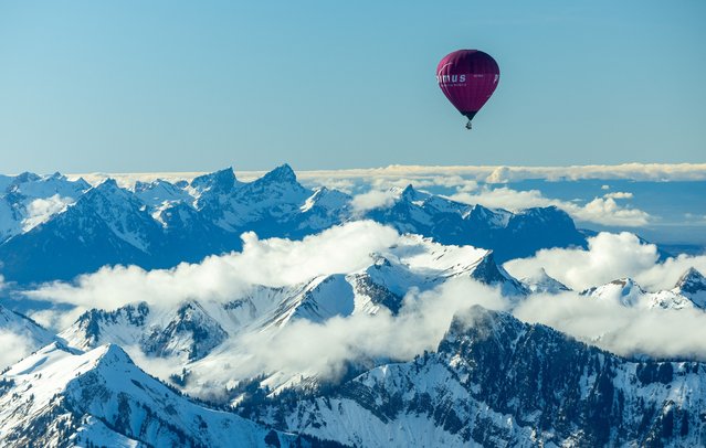 A balloon takes part in the 44th International Hot Air Balloon Festival in Chateau-d'Oex, Switzerland on January 25, 2024. (Photo by Denis Balibouse/Reuters)