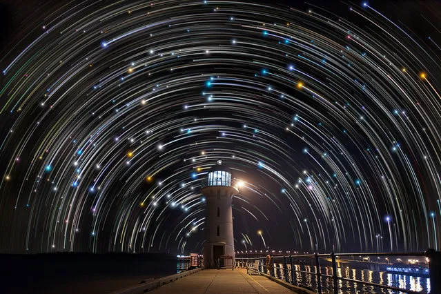 Star trails photographed by Justin Ng seen behind a lighthouse in Tuas, Singapore. These astonishing images of night sky are captured by Singapore based photographer Justin Ng. The pictures were taken between November 2013 to January 2014. It show's star trail caused by the earth's rotation and also can be achieved by zooming the DSLR lens inward or outward in small steps using a dedicated motorized zooming device. (Photo by  Justin Ng/Barcroft Media)